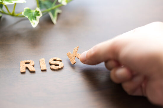 机の上にRISKの木の文字を並べる手元