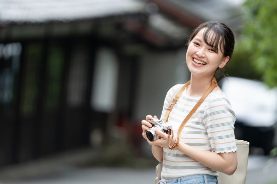 旅行先でのカメラ撮影を楽しんでいる歯並びの整った女性